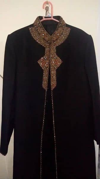 Black Shadi Sherwani with Red Kulla and White Kurta Pajama

                                                            alt=